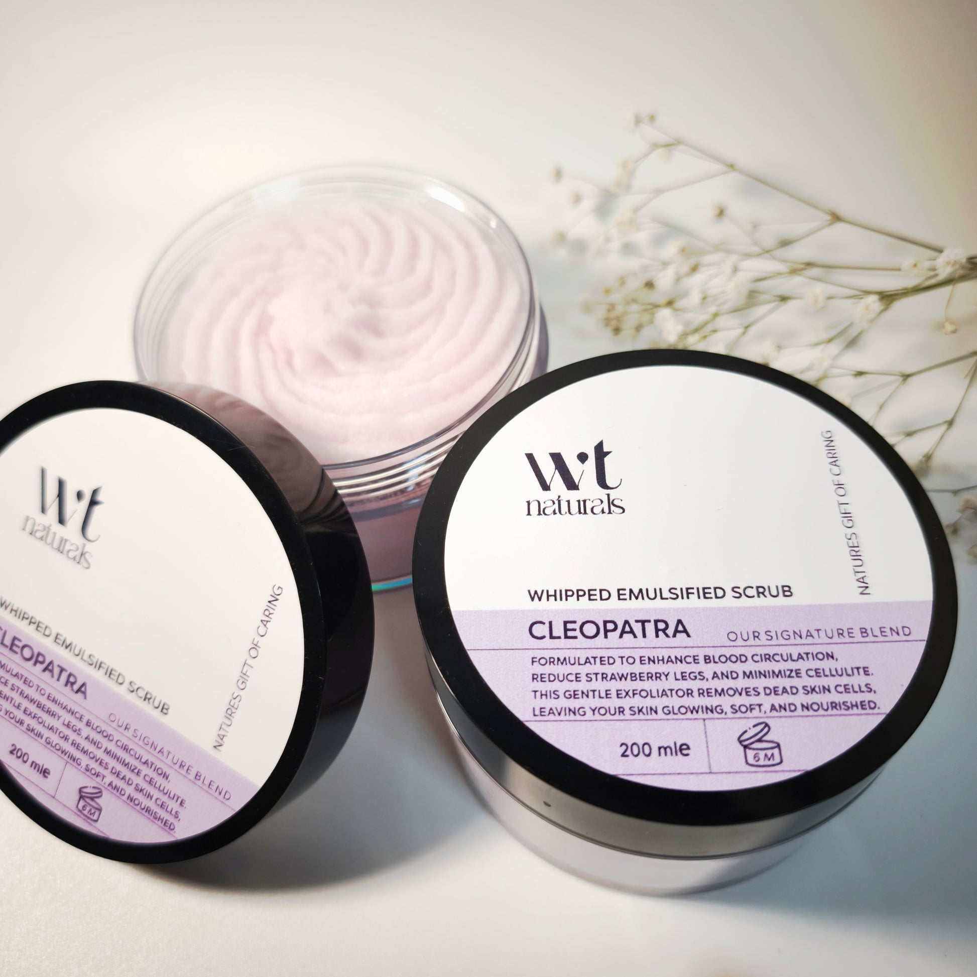 Two containers of WT Naturals Whipped Emulsified Scrub Cleopatra on a light background.